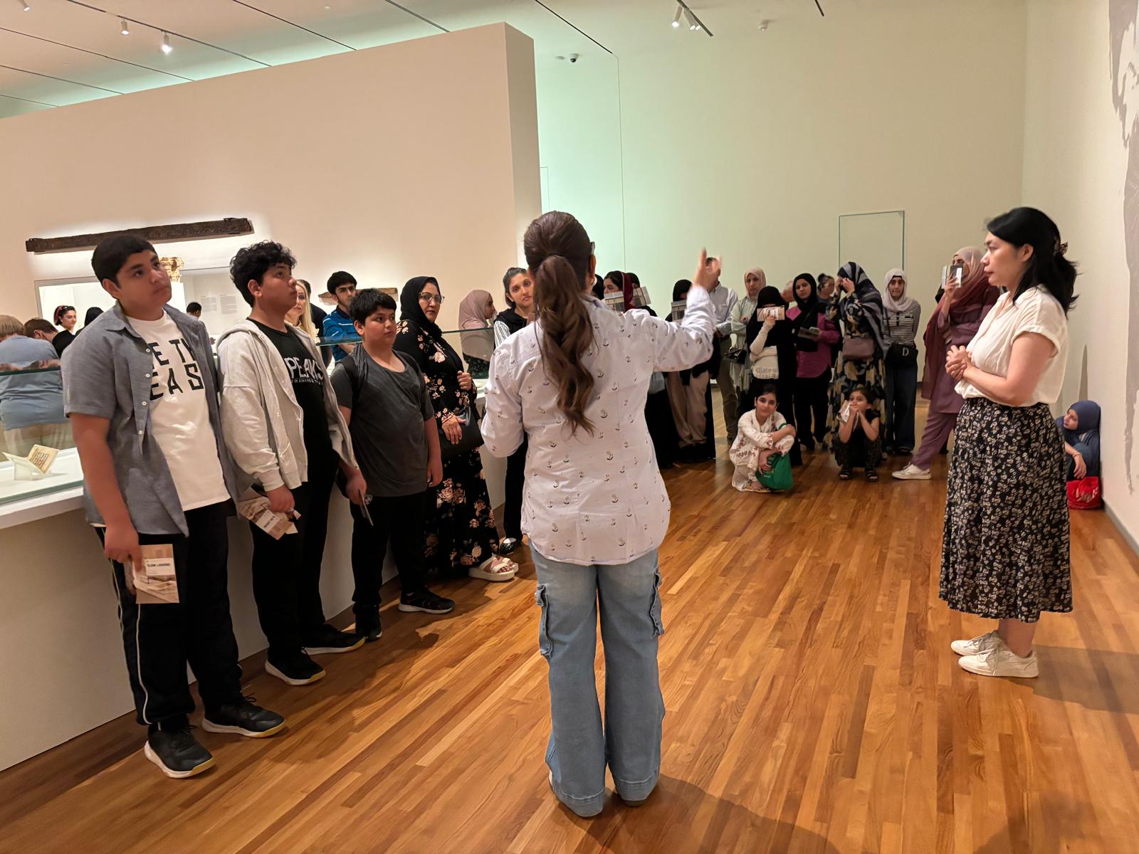Families listening to a museum educator