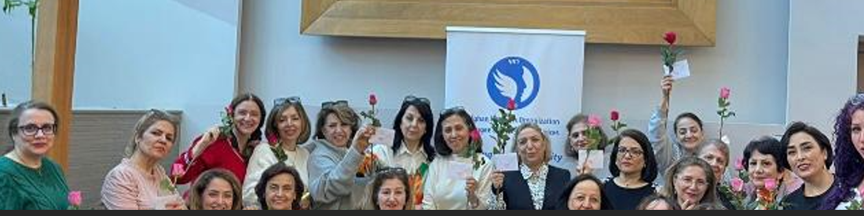 AWO community members gathered together holding flowers